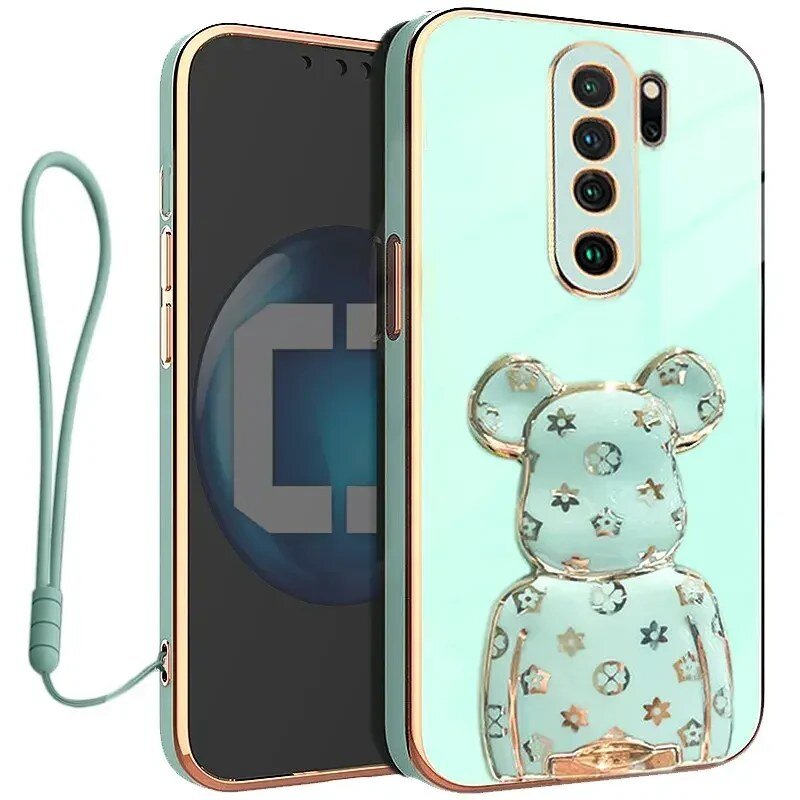 Etui na telefon w kolorze miętowym z przezroczystym uchwytem w kształcie misia ozdobionym gwiazdkami i kółkami. Do etui dołączona jest smycz w tym samym kolorze.