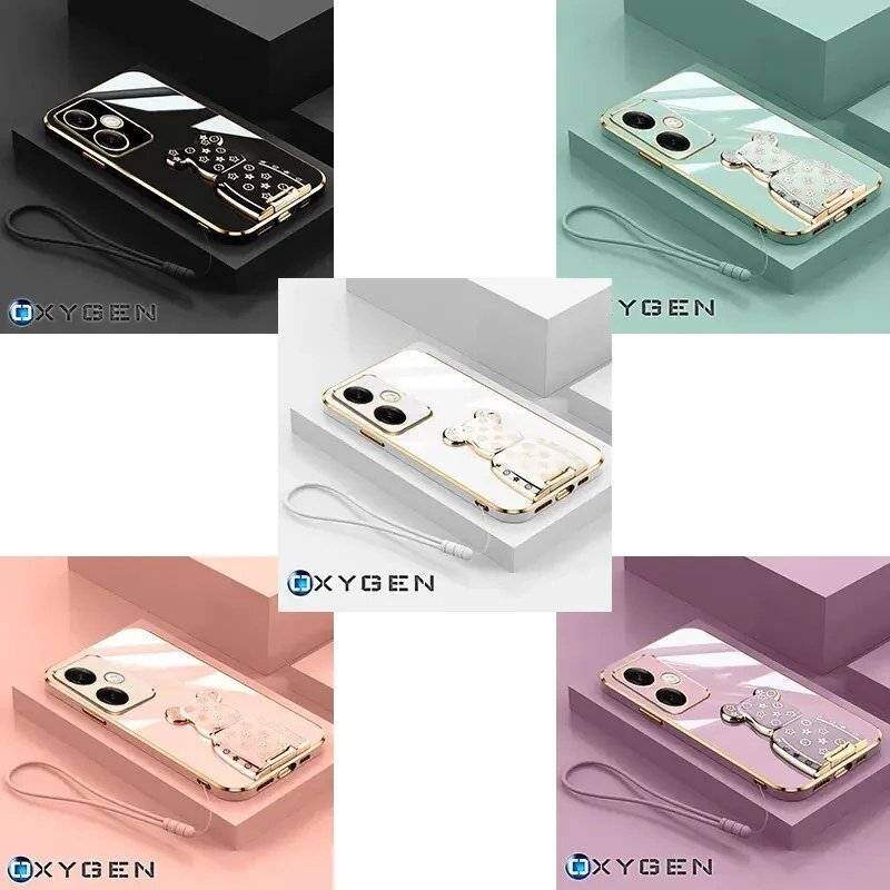 Obraz przedstawia pięć etui na telefon w różnych kolorach, każde z uchwytem w kształcie misia i smyczą. Widoczne jest logo \'OXYGEN\'.