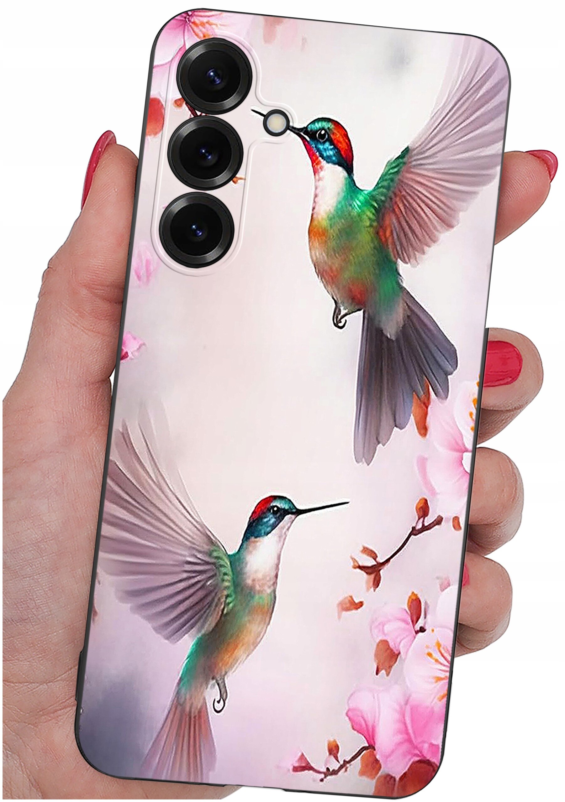 Etui na telefon z kolorowym wzorem przedstawiającym dwa kolibry w locie na tle kwiatów. Etui jest trzymane w dłoni, a na górze widoczne są trzy otwory na aparaty.