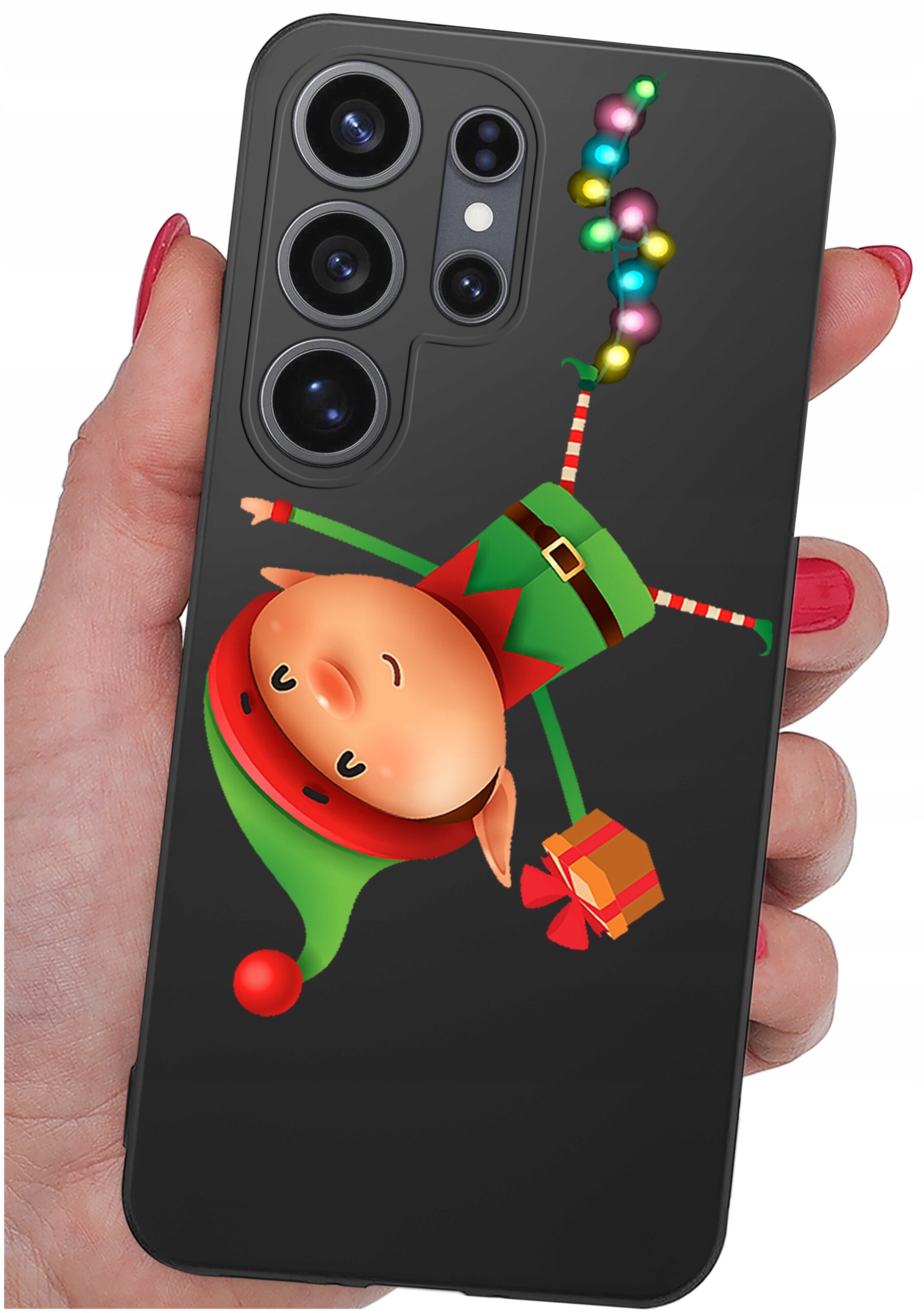 Etui na telefon z motywem świątecznym przedstawiającym elfa w zielono-czerwonym stroju, trzymającego prezent. W tle widoczne są kolorowe światełka.
