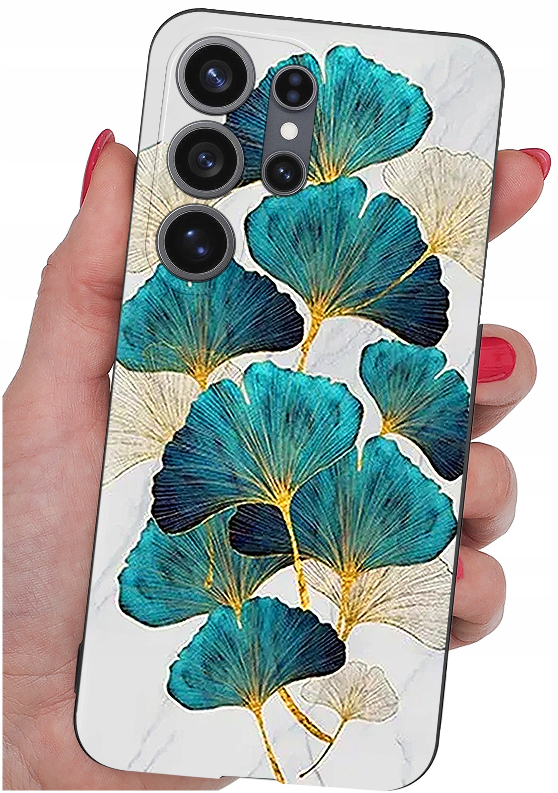 Etui na telefon z wzorem liści w odcieniach niebieskiego i złotego, trzymane w dłoni. Widoczne są cztery otwory na aparaty fotograficzne.