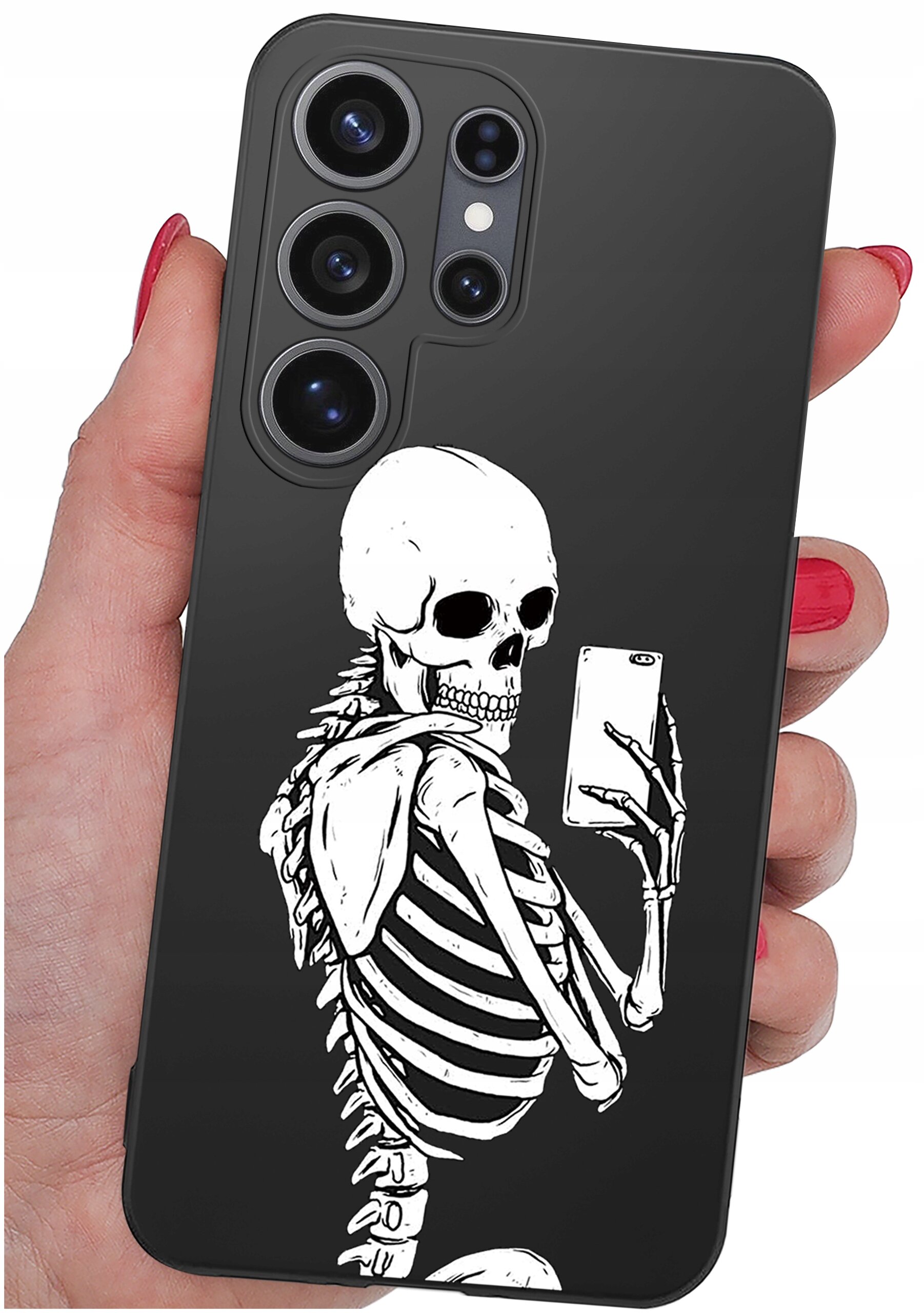 Czarne etui na telefon z nadrukiem białego szkieletu trzymającego smartfon. Etui jest trzymane w dłoni z czerwonymi paznokciami.