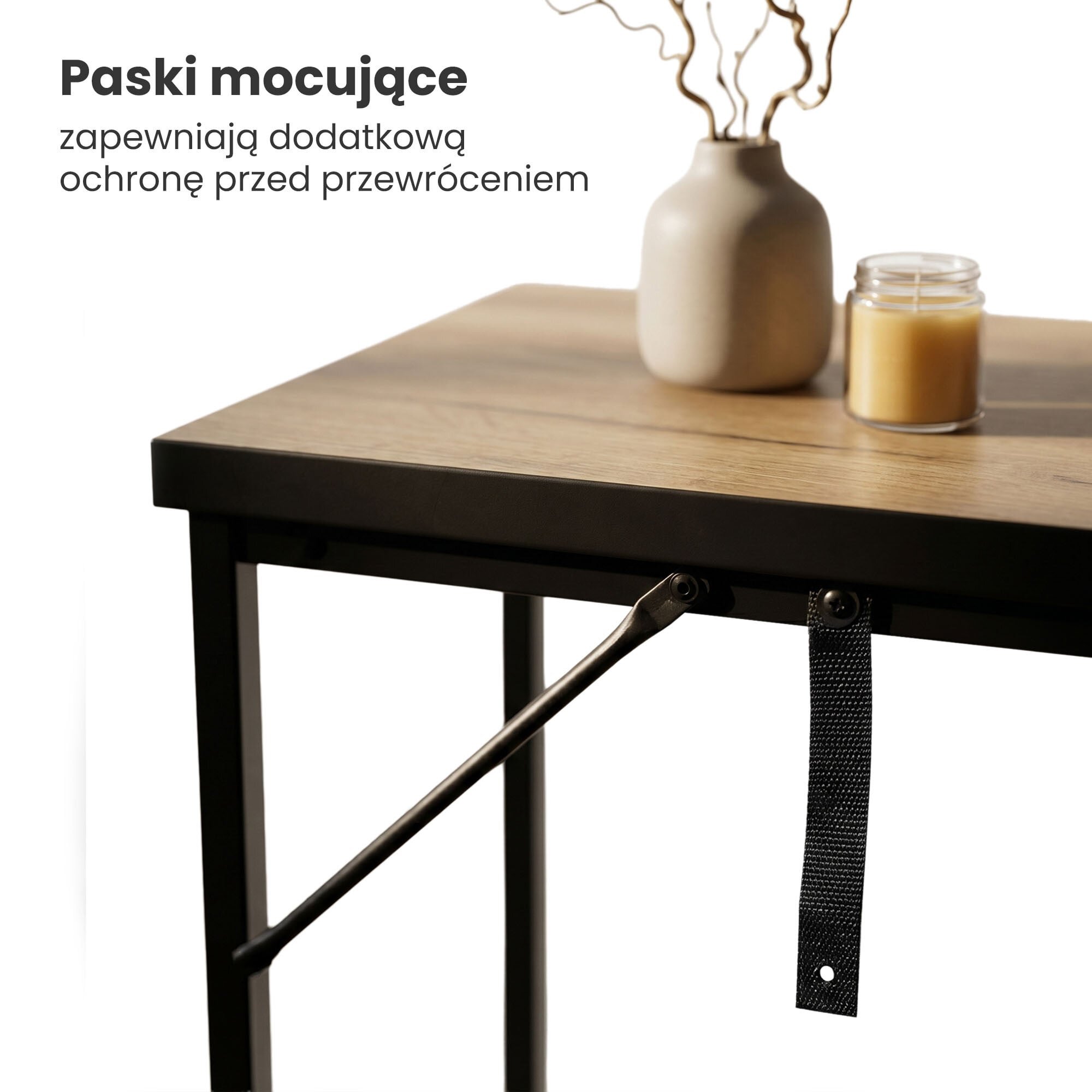 Stolik z blatem w kolorze dębu i czarnymi nogami, na którym stoi wazon i świeca. Tekst na obrazie: \'Paski mocujące zapewniają dodatkową ochronę przed przewróceniem\'.