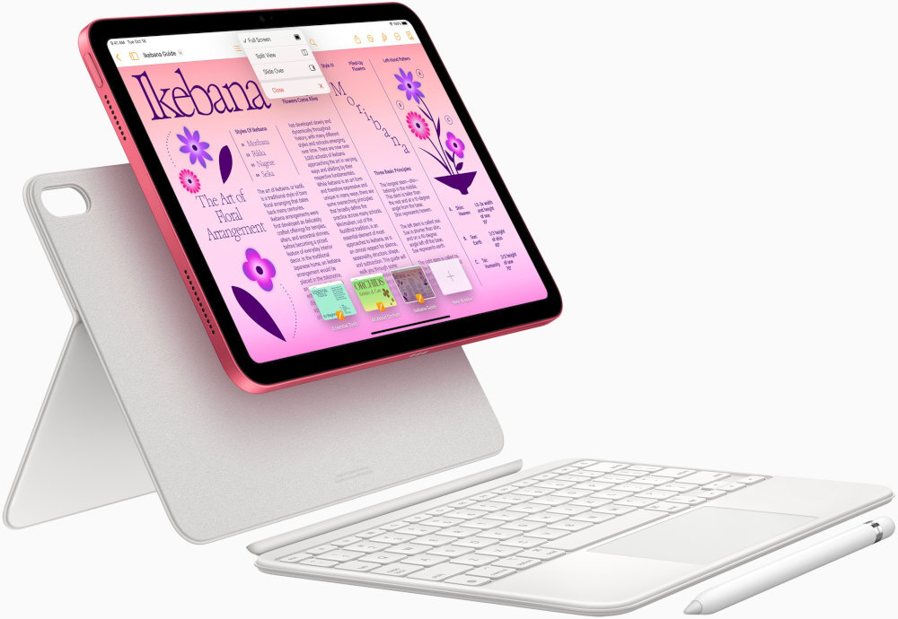 Tablet z ekranem wyświetlającym kolorowy interfejs z tekstem \'Ikebana\' i grafiką kwiatów, umieszczony na białej klawiaturze z podpórką. Obok znajduje się biały rysik.