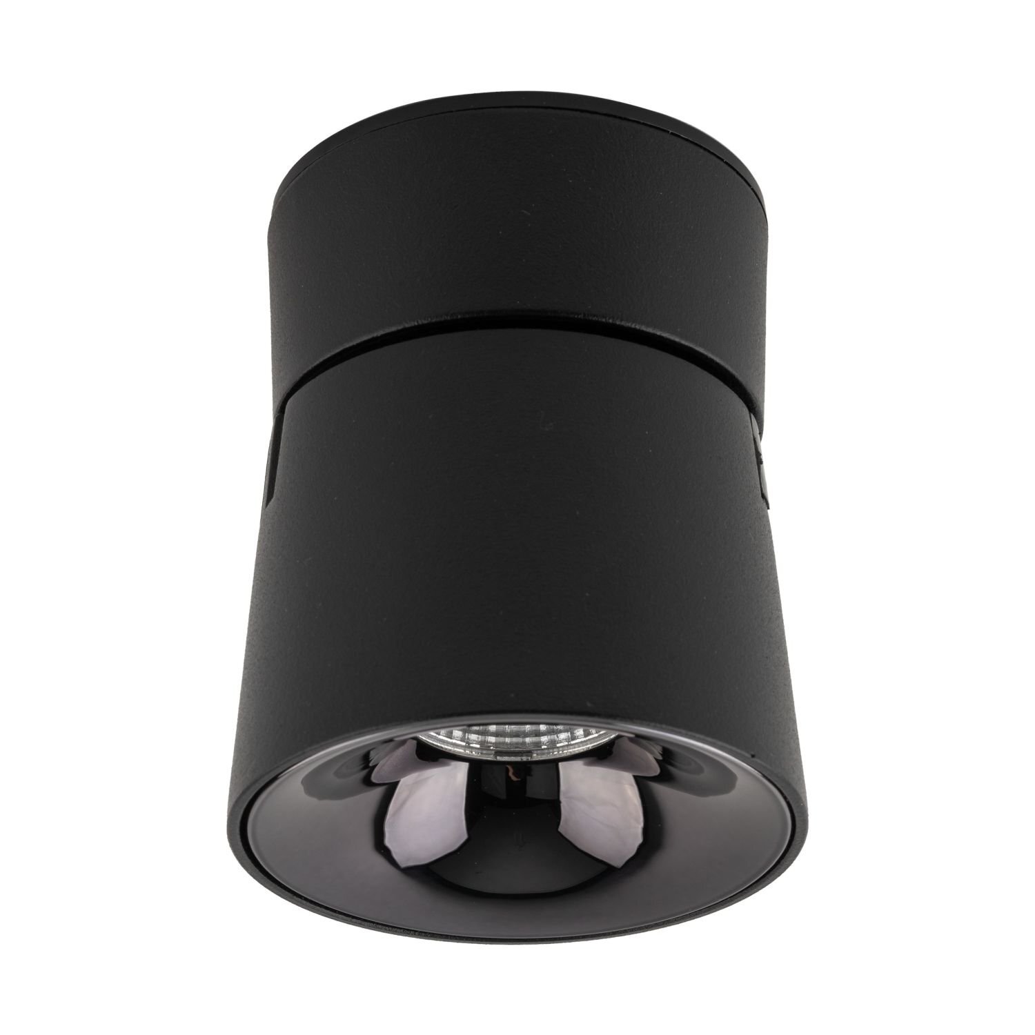 Czarna lampa reflektorowa LED o cylindrycznym kształcie z widocznym odbłyśnikiem wewnątrz. Powierzchnia lampy jest matowa, a konstrukcja umożliwia ruchome ustawienie.