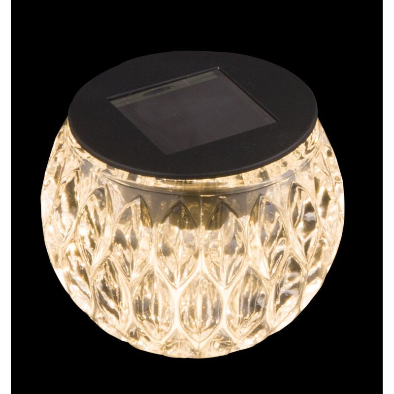 Szklana lampa solarna o fakturze przypominającej diamenty, z czarnym panelem solarnym na górze.