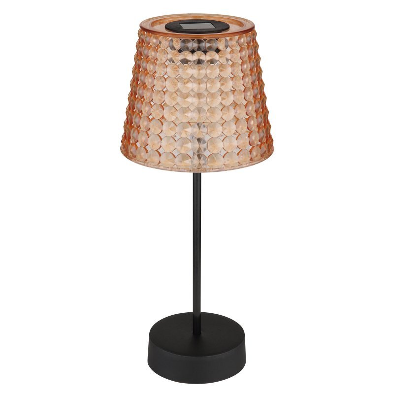 Lampa stołowa z czarną podstawą i trzonkiem, posiada klosz o fakturze przypominającej kryształki w kolorze miedzianym. Na górze klosza znajduje się panel solarny.