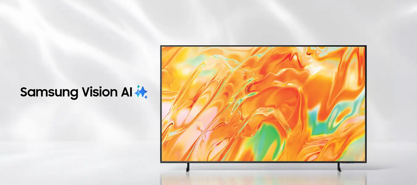 Obraz przedstawia telewizor z wyświetlonym abstrakcyjnym, kolorowym wzorem w odcieniach pomarańczowego i zielonego. Obok znajduje się tekst \'Samsung Vision AI\' z niebieskim symbolem gwiazdy.