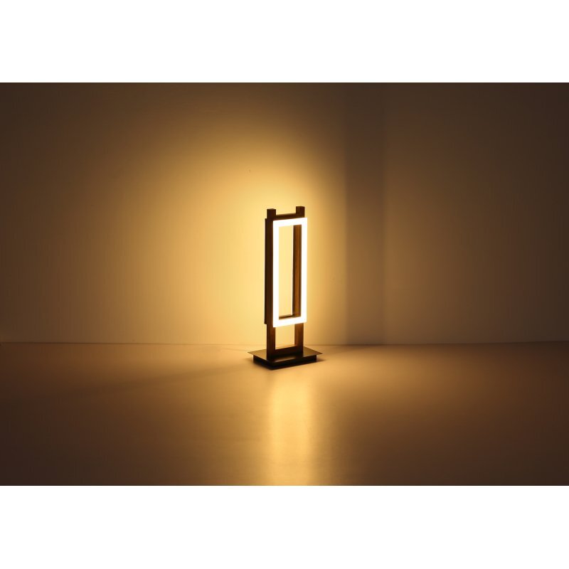 Lampa stołowa LED o nowoczesnym designie, emitująca ciepłe światło, stoi na płaskiej powierzchni. Konstrukcja lampy jest prostokątna, wykonana z czarnego matowego materiału i drewna MDF.