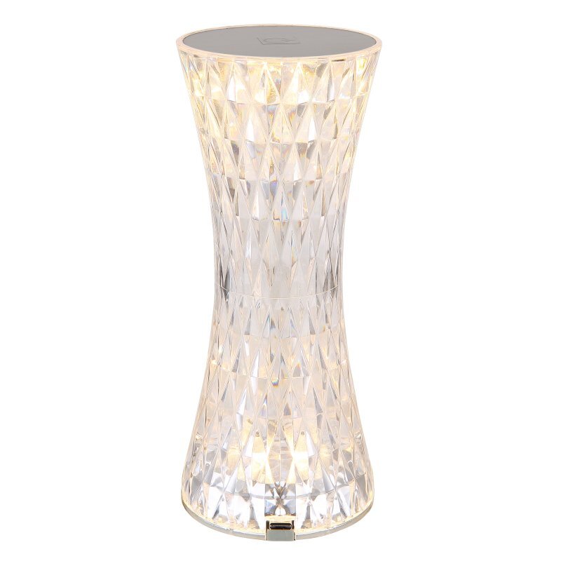 Lampa stołowa LED o kształcie klepsydry, wykonana z akrylu o kryształowym wyglądzie, emituje jasne światło. Górna część lampy jest srebrna z dotykowym panelem.