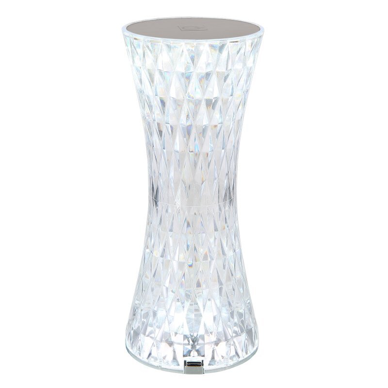 Lampa stołowa LED o kształcie klepsydry, wykonana z przezroczystego materiału o kryształowym wzorze. Na górze znajduje się płaska powierzchnia, a u dołu widoczny jest port USB.