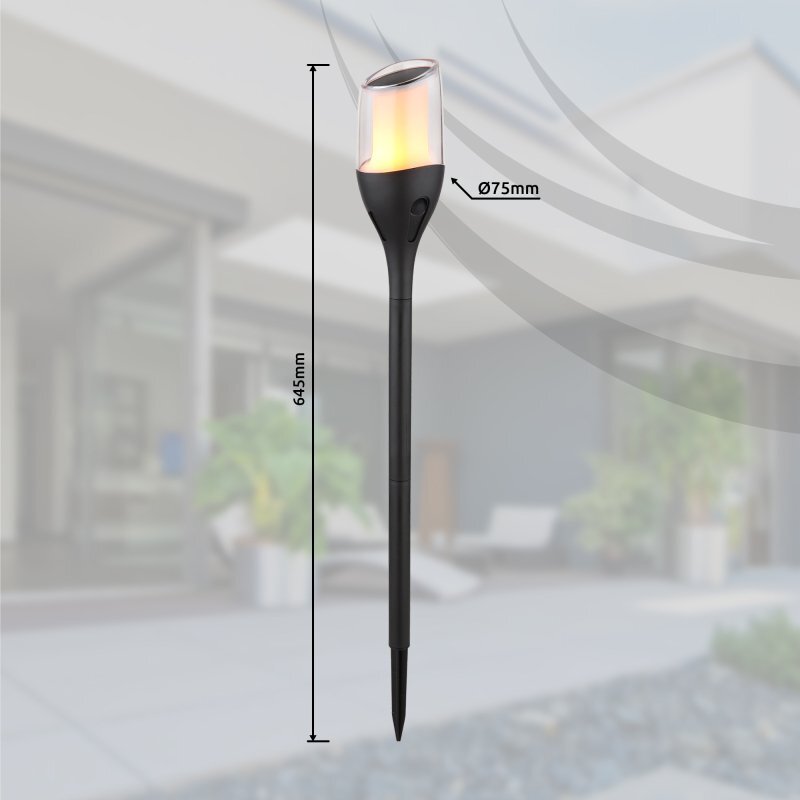 Lampa solarna dogruntowa LED z czarnym korpusem i przezroczystym kloszem, o wysokości 645 mm i średnicy 75 mm. W tle widoczny jest rozmyty obraz ogrodu z nowoczesnym budynkiem.