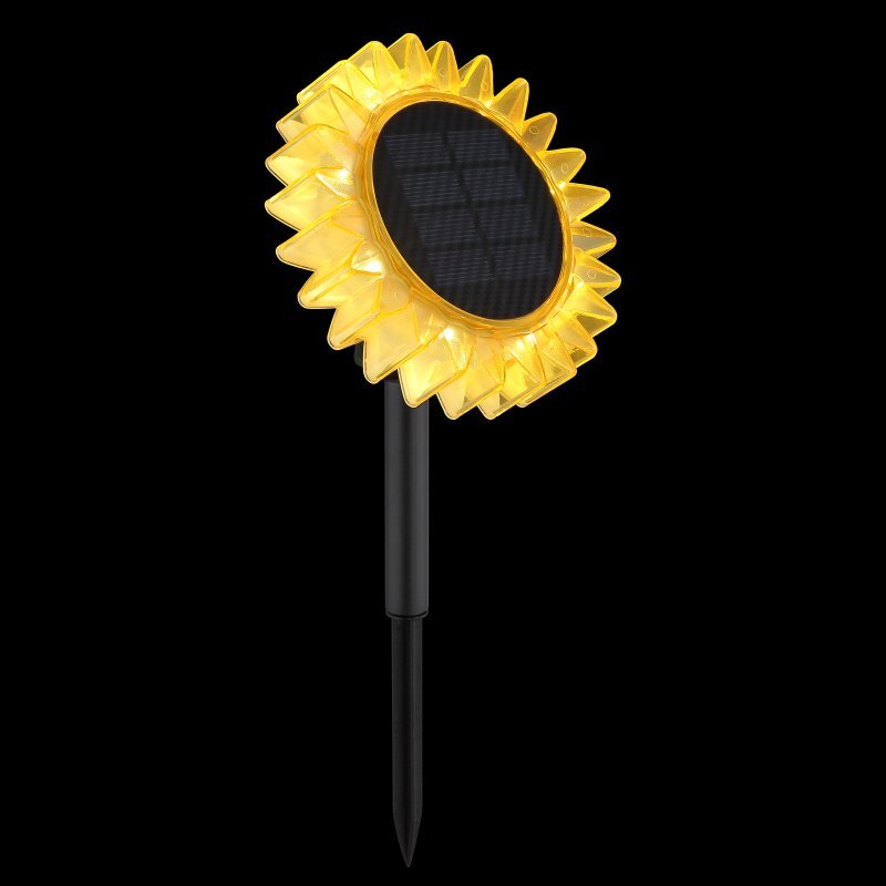 Lampa solarna w kształcie słonecznika z żółtymi płatkami i czarnym panelem solarnym na środku, zamontowana na czarnym pręcie. Tło jest jednolicie czarne.