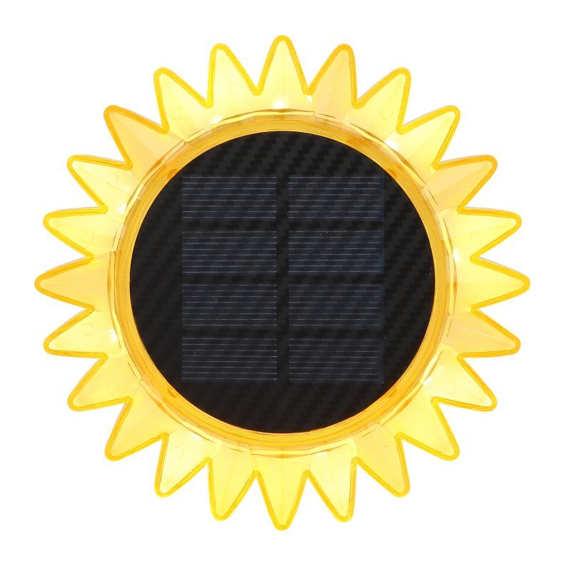 Obraz przedstawia lampę solarną w kształcie słonecznika z żółtymi promieniami i ciemnym panelem solarnym w centrum.