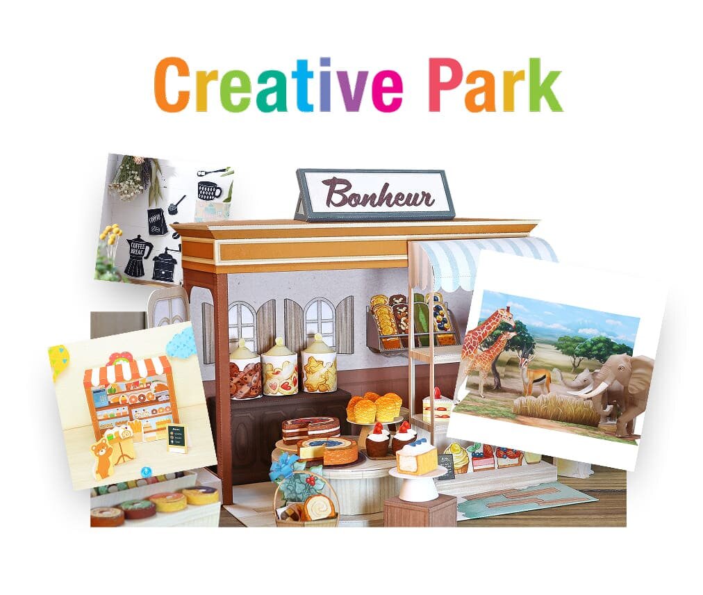 Kolorowy model sklepu z napisem \'Bonheur\' na dachu, otoczony papierowymi dekoracjami i ilustracjami zwierząt. Nad sceną widnieje napis \'Creative Park\'.