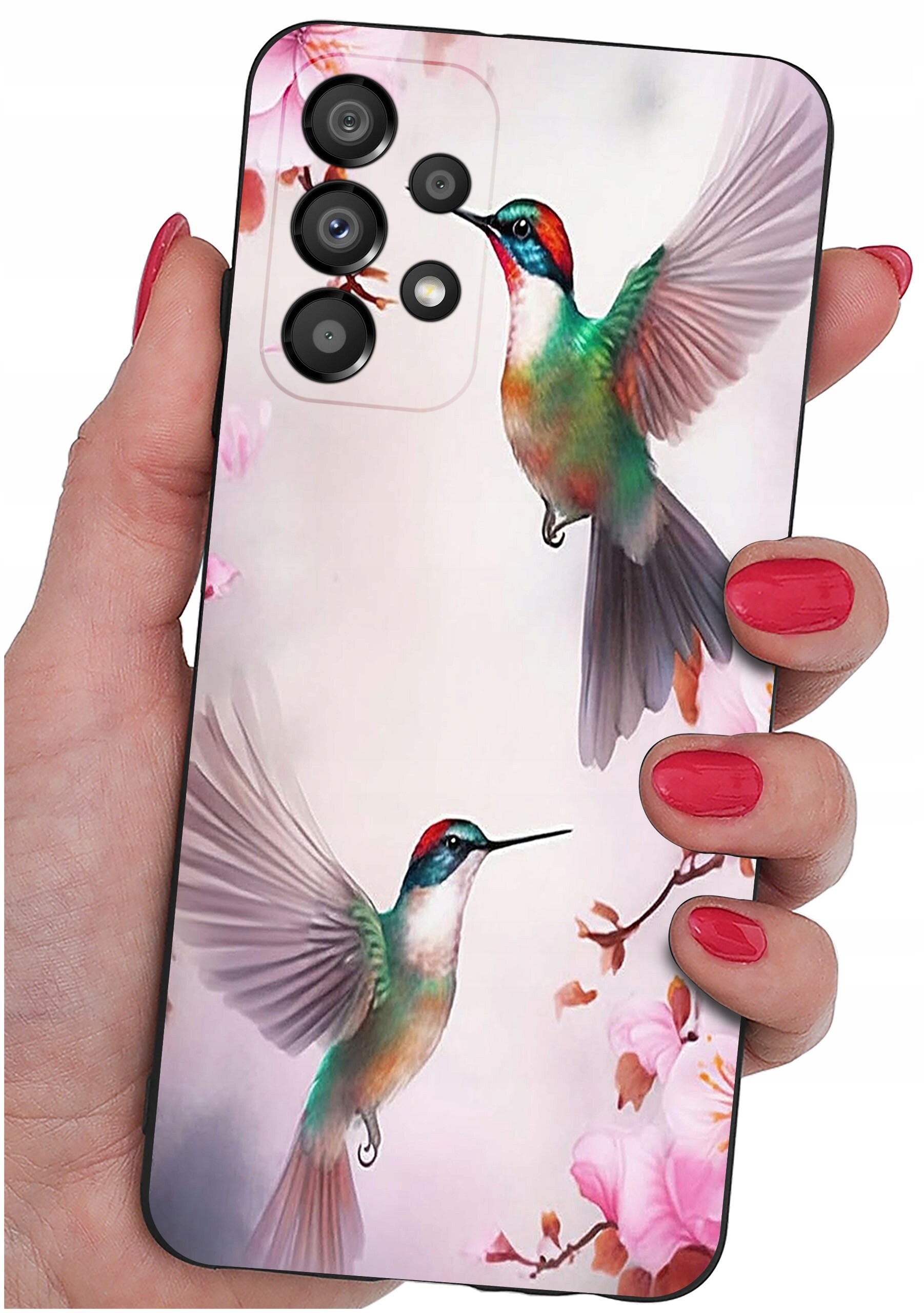 Etui na telefon z kolorowym wzorem przedstawiającym dwa kolibry w locie na tle kwiatów. Etui trzymane jest w dłoni z pomalowanymi na czerwono paznokciami.