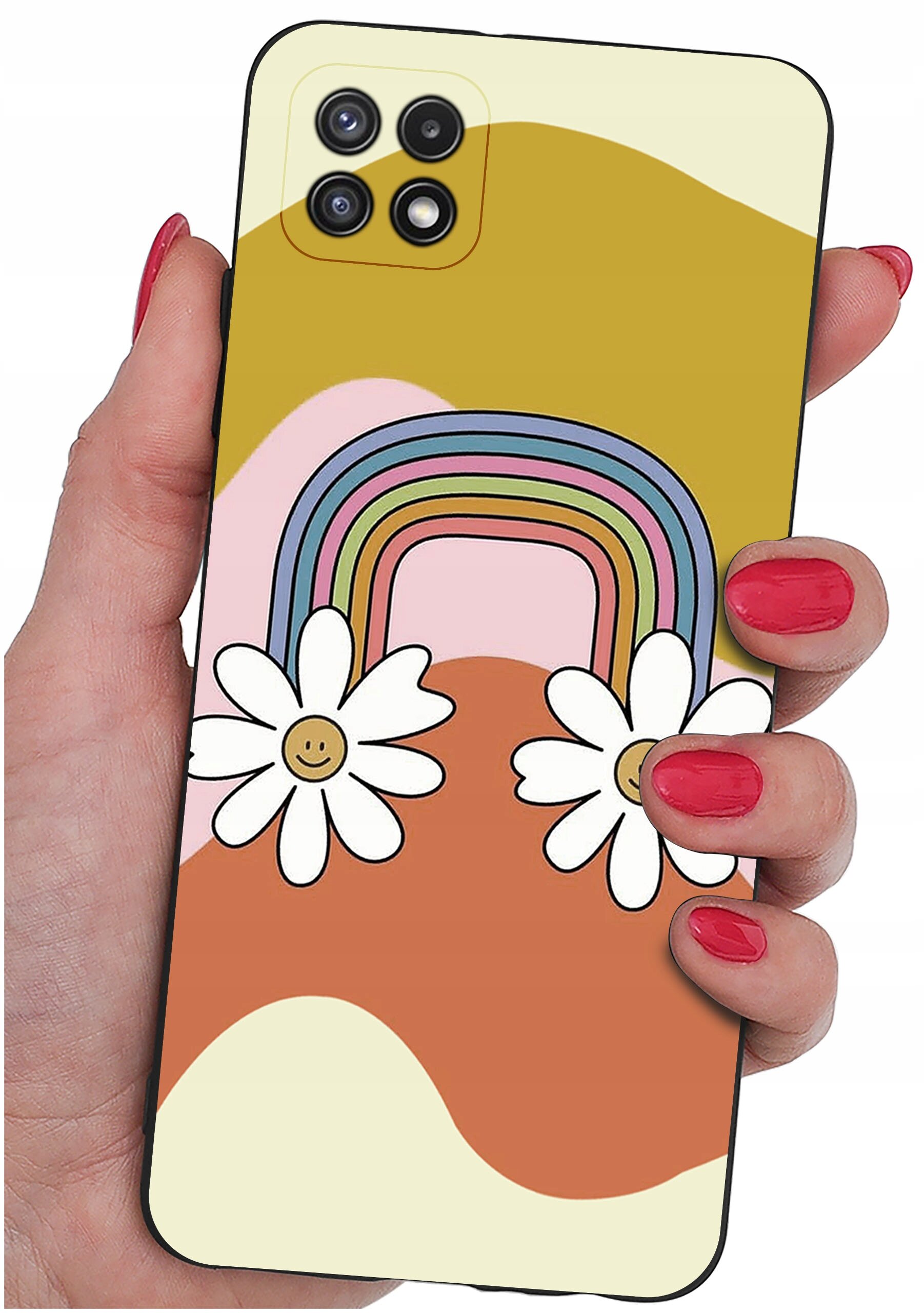 Etui na telefon z kolorowym wzorem tęczy i dwoma kwiatami z uśmiechniętymi buźkami. Etui jest trzymane w dłoni z pomalowanymi na czerwono paznokciami.
