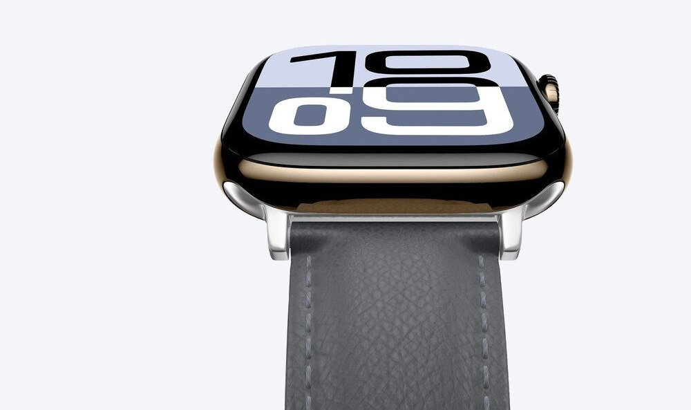 Zbliżenie złotej koperty smartwatcha Apple Watch z szarym paskiem AmazingThing Class Band, widoczne przeszycie i srebrne zapięcie.