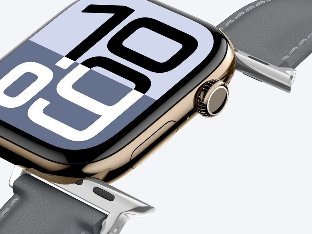 Boczny widok złotej koperty Apple Watch z szarym paskiem AmazingThing Class Band, widoczna koronka cyfrowa i srebrne łączniki paska.