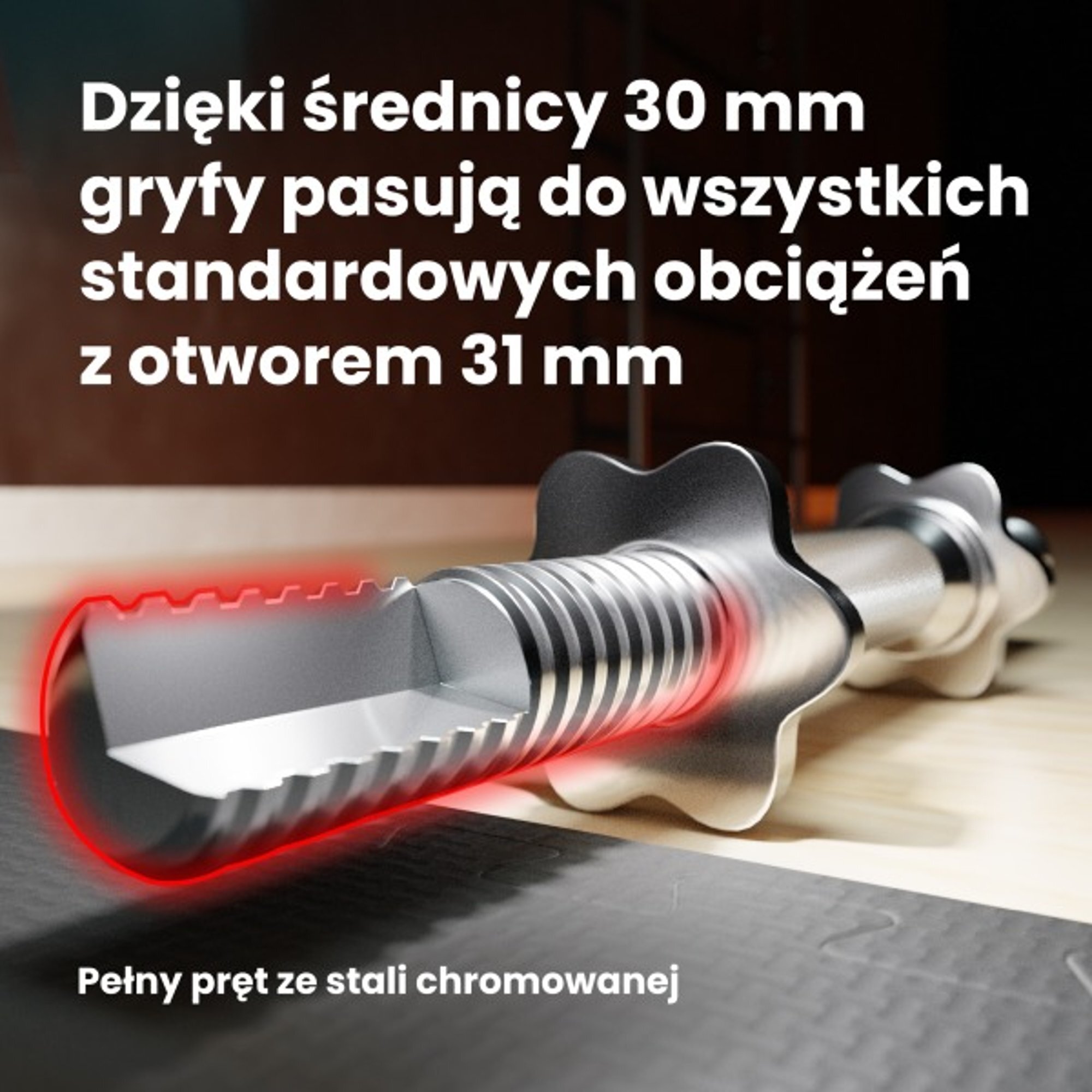 Na obrazie widoczny jest chromowany gryf z tekstem: \'Dzięki średnicy 30 mm gryfy pasują do wszystkich standardowych obciążeń z otworem 31 mm\'.