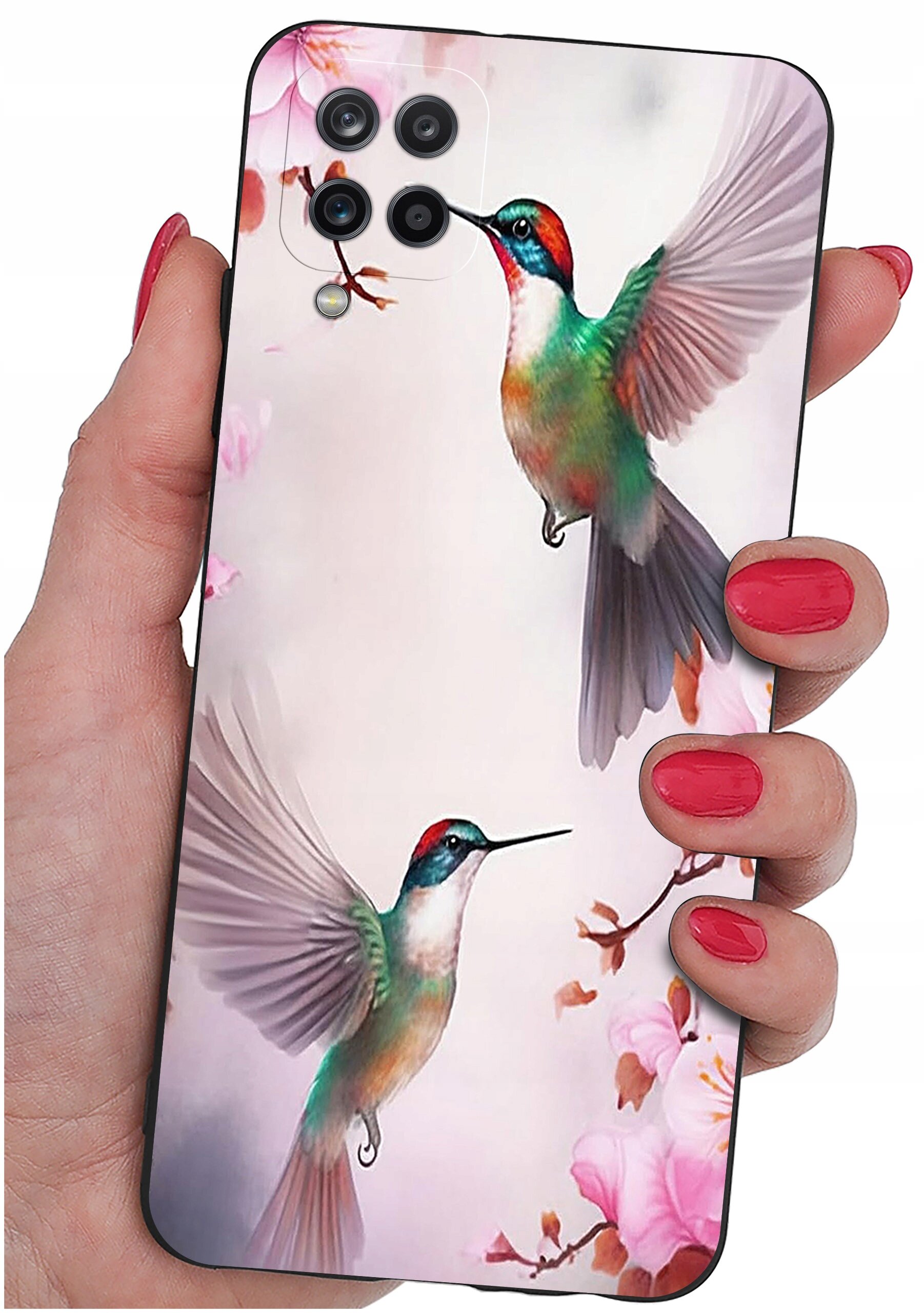 Etui na telefon z kolorowym wzorem przedstawiającym dwa kolibry w locie na tle kwiatów. Etui trzymane jest w dłoni z pomalowanymi na czerwono paznokciami.