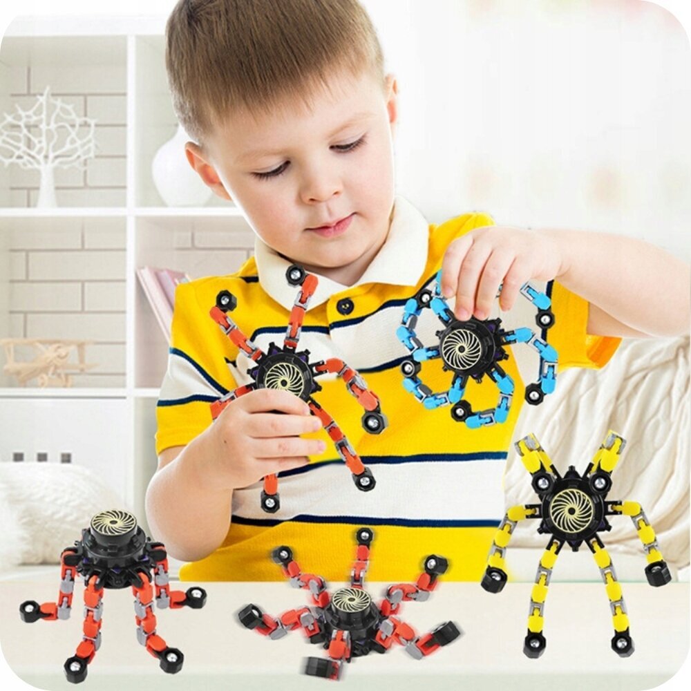 Dziecko bawi się składanymi zabawkami sensorycznymi w kształcie robotów z kolorowymi ramionami. Na stole znajdują się trzy podobne zabawki w różnych kolorach.