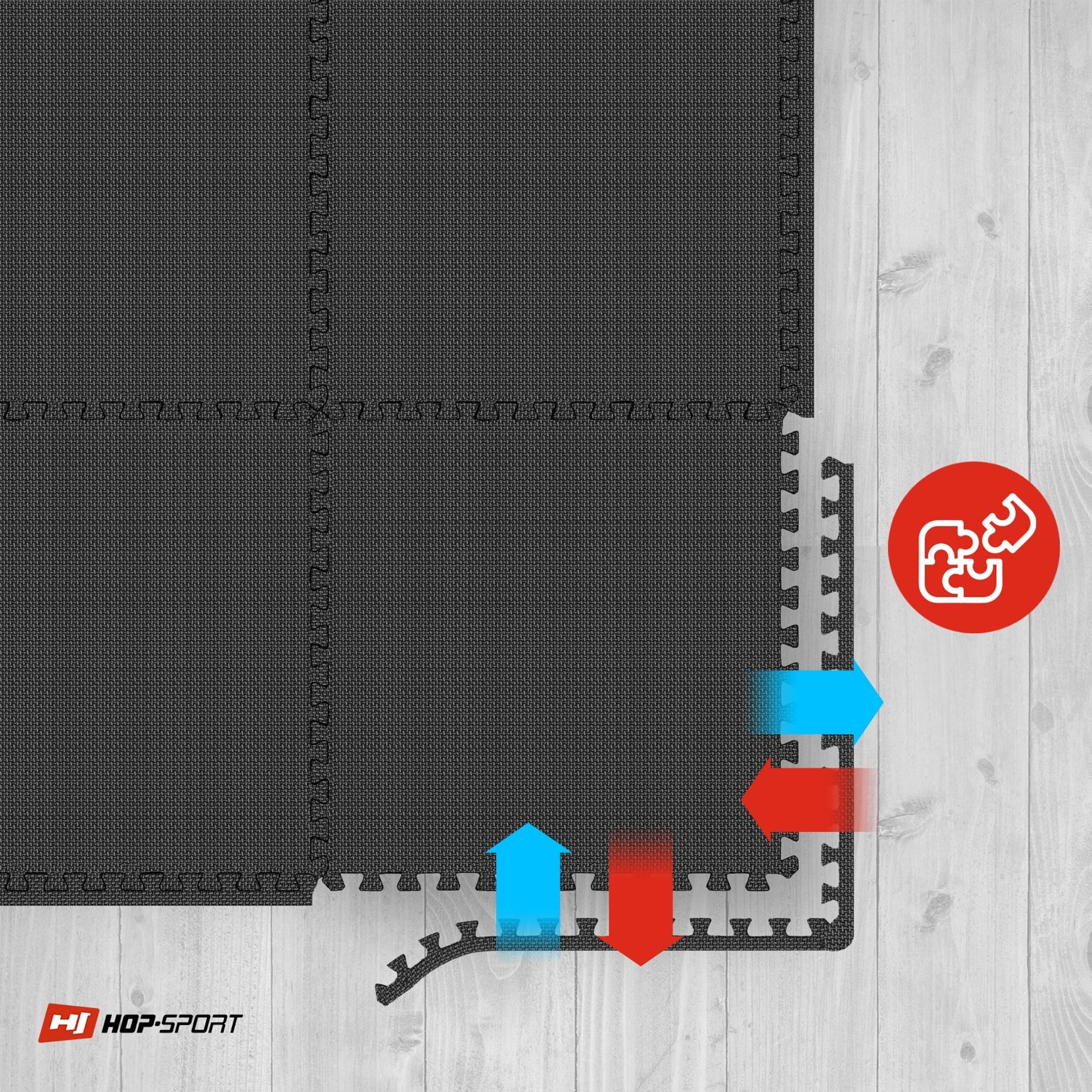 Czarna mata puzzle EVA o grubości 1 cm, składająca się z sześciu elementów, ułożona na drewnianej podłodze. W prawym dolnym rogu znajduje się logo HOP-SPORT oraz czerwone koło z białym symbolem puzzli.