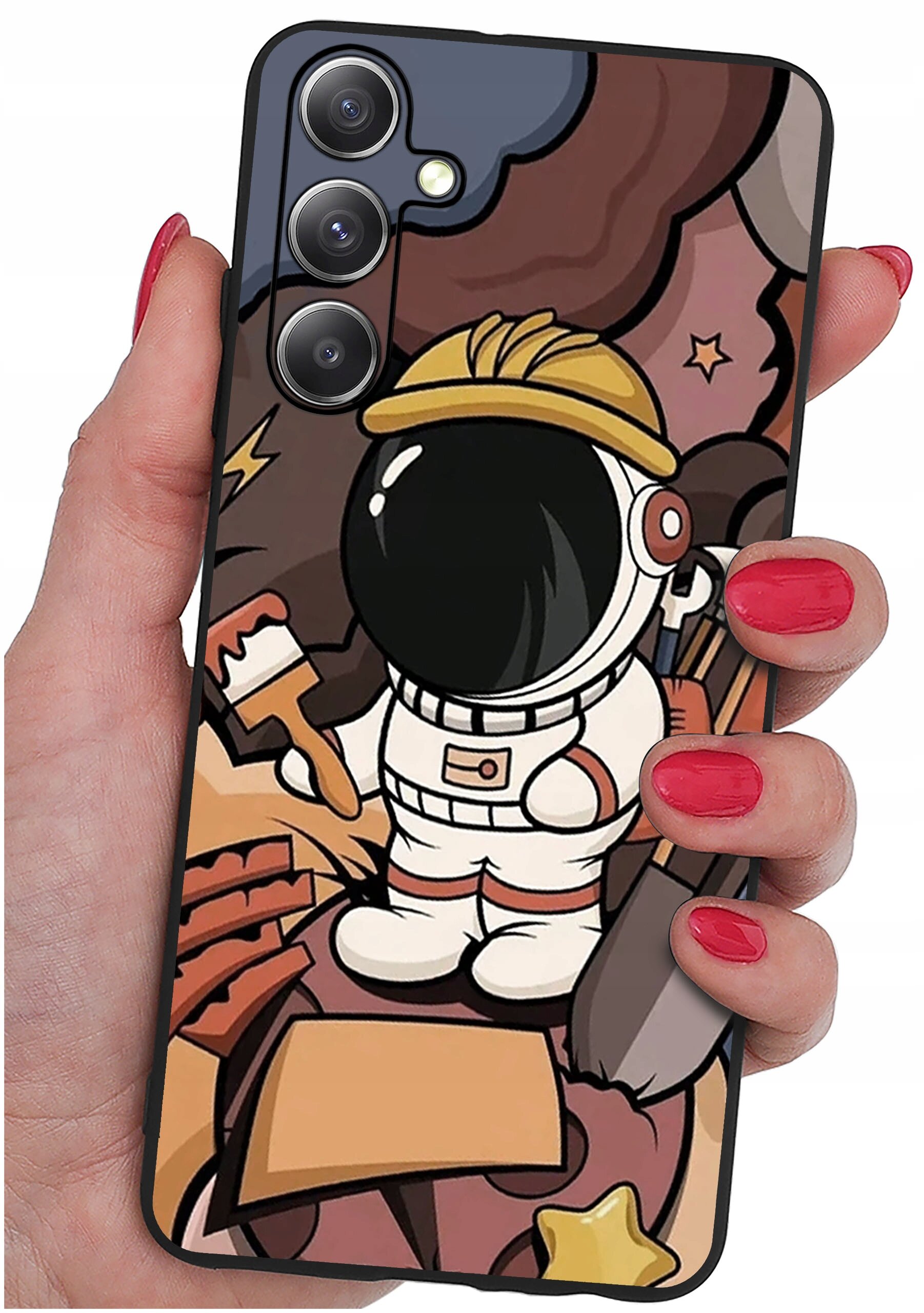 Etui na telefon z kolorowym wzorem przedstawiającym postać astronauty w kasku, trzymającego pędzel i łopatę. Tło jest w odcieniach brązu i różu z gwiazdkami.