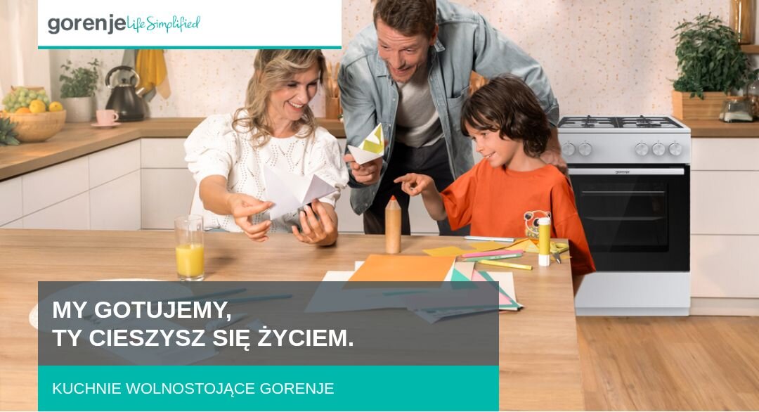 Na obrazie widać rodzinę przy stole w kuchni, obok stoi biały piekarnik. Widoczny tekst: \'MY GOTUJEMY, TY CIESZYSZ SIĘ ŻYCIEM. KUCHNIE WOLNOSTOJĄCE GORENJE\'.
