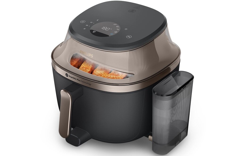 Frytkownica beztłuszczowa z przezroczystą pokrywą, przez którą widać jedzenie. Na urządzeniu widoczne są napisy: \'PHILIPS\' i \'Rapid Air Plus Technology\'.