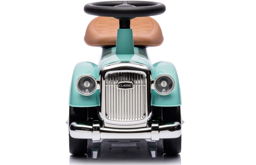 Jeździk w stylu retro w kolorze miętowym z brązowym siedzeniem i kierownicą. Na przodzie widoczny jest napis \'CLASSIC\' na srebrnym grillu.