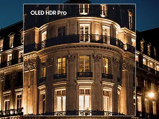 320x240-oled-hdr Zdjęcie przedstawia fasadę eleganckiego budynku oświetlonego nocą, z widocznym napisem \'OLED HDR Pro\' w lewym górnym rogu. Budynek ma liczne okna i balkony, a światło podkreśla jego architektoniczne detale.