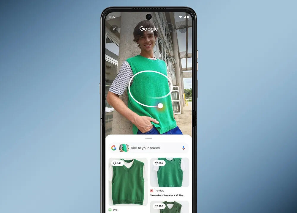 Smartfon wyświetla aplikację Google z funkcją wyszukiwania wizualnego, pokazującą zielony bezrękawnik na osobie oraz podobne produkty z cenami  i . W tle widoczna jest architektura z dużymi oknami.