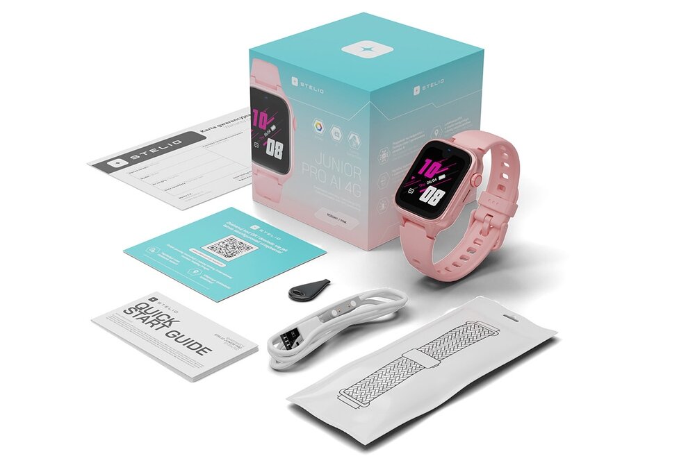 Na obrazie znajduje się różowy smartwatch z wyświetlaczem, obok którego leży pudełko z napisem \'STELIO Junior Pro AI 4G\'. Wokół znajdują się akcesoria, takie jak przewód, instrukcja \'Quick Start Guide\' i inne elementy zestawu.