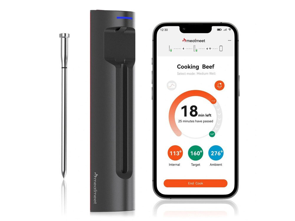 Na obrazie widoczny jest termometr do żywności oraz smartfon z aplikacją pokazującą czas gotowania i temperatury: \'Cooking Beef\', \'18 min left\', \'113° Internal\', \'160° Target\', \'276° Ambient\'. Logo \'meatmeet\' znajduje się na obu urządzeniach.