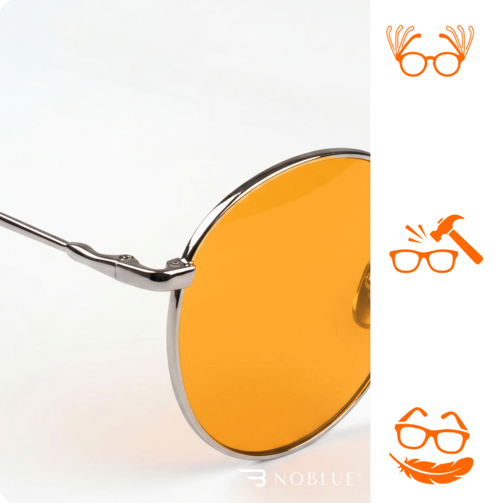 Obraz przedstawia okulary z pomarańczowymi soczewkami i metalową oprawką. W prawym dolnym rogu widoczne jest logo \'NOBLUE\'.