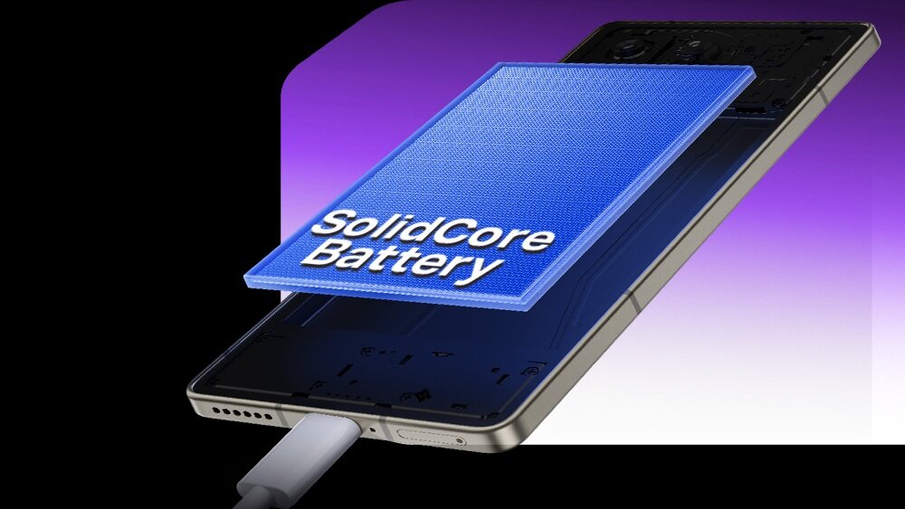 Obraz przedstawia smartfon z widocznym napisem \'SolidCore Battery\' na niebieskim tle, z podłączonym kablem do ładowania. Tło jest gradientowe, przechodzące od fioletu do bieli.