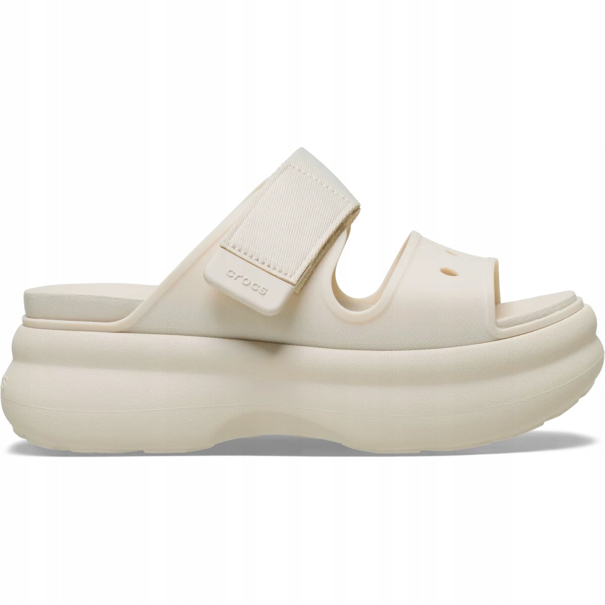 Beżowe sandały z grubą podeszwą i dwoma paskami, na jednym z nich widoczny jest napis \'crocs\'.