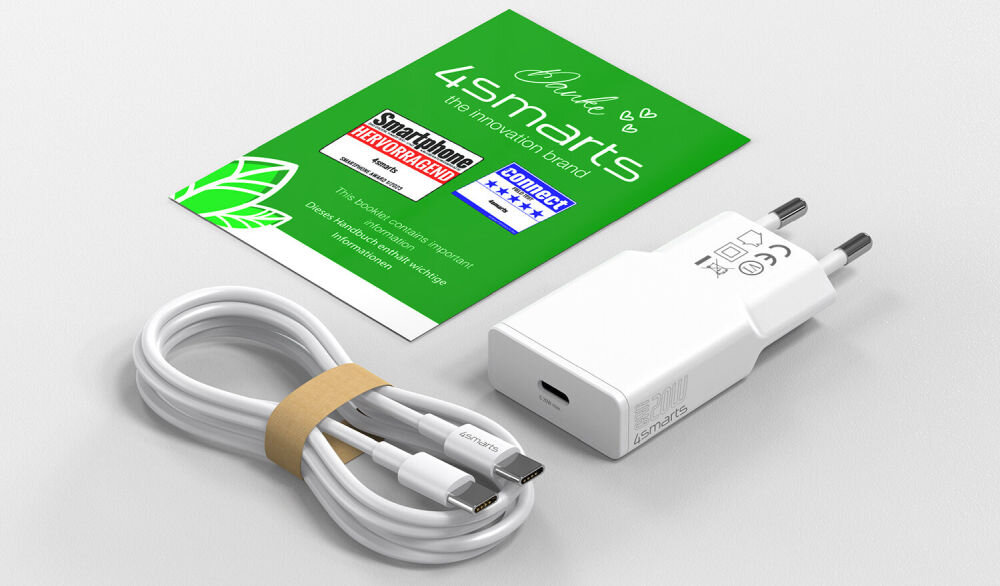 Na obrazie znajduje się biała ładowarka sieciowa z logo \'4smarts\' oraz kabel USB-C z opaską. Obok leży zielona ulotka z napisem \'4smarts the innovation brand\' oraz informacjami o certyfikatach i wydajności.