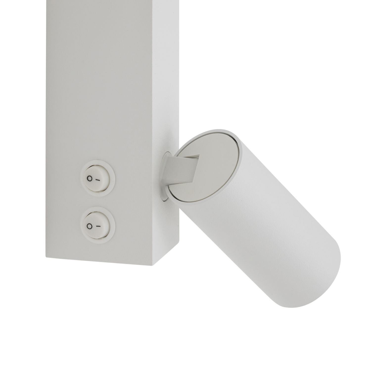 Biała lampa ścienna z reflektorem o cylindrycznym kształcie, zamontowana na prostokątnej podstawie z dwoma okrągłymi przyciskami oznaczonymi symbolami \'O\' i \'-\'.