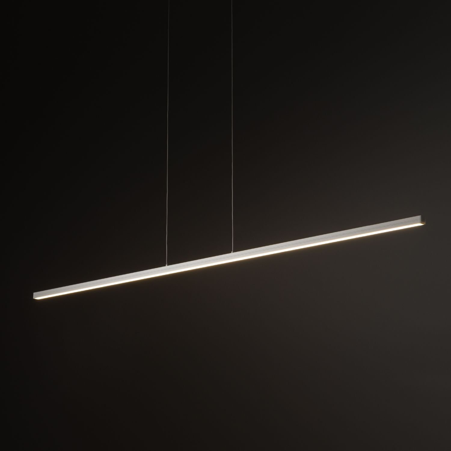 Na obrazie widoczna jest nowoczesna lampa wisząca LED o prostym, liniowym kształcie, zawieszona na dwóch cienkich przewodach. Tło jest ciemne, co podkreśla jasność emitowanego światła.