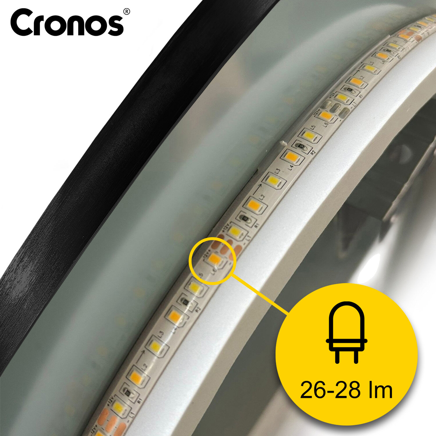 Obraz przedstawia zbliżenie na krawędź okrągłego lustra z podświetleniem LED. Widoczne jest logo \'Cronos\' oraz żółty symbol LED z oznaczeniem \'26-28 lm\'.