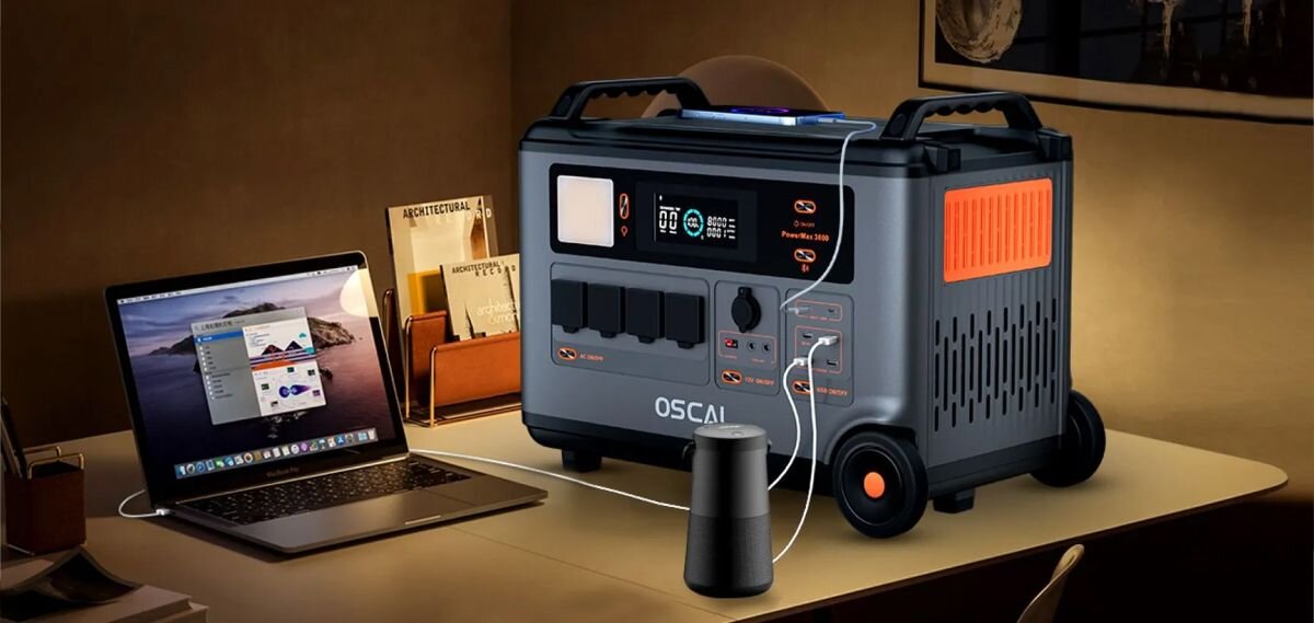 Stacja zasilania OSCAL PowerMax 3600 SE 3600Wh, cicho, hałas, komfort, dom, PowerMax 3600SE na biurku obok laptopa i mikrofonu, w ciepłym świetle.