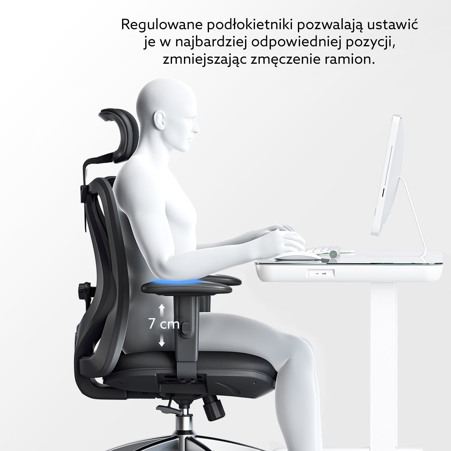 Obraz przedstawia manekina siedzącego na ergonomicznym fotelu biurowym przy biurku z komputerem. Tekst na obrazie: \'Regulowane podłokietniki pozwalają ustawić je w najbardziej odpowiedniej pozycji, zmniejszając zmęczenie ramion.\'