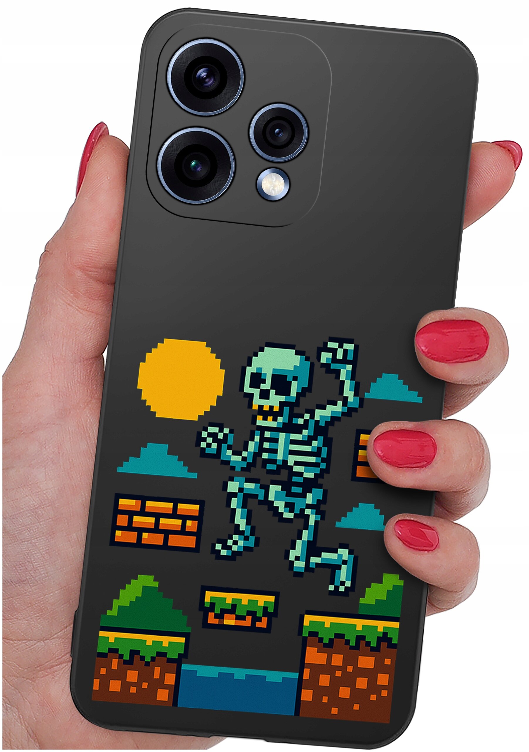 Osoba trzyma telefon z etui przedstawiającym pikselową grafikę szkieletu skaczącego w scenerii przypominającej grę wideo, z elementami takimi jak słońce, chmury i platformy. Etui jest ciemne, a grafika jest kolorowa z dominującymi odcieniami niebieskiego, zielonego i pomarańczowego.