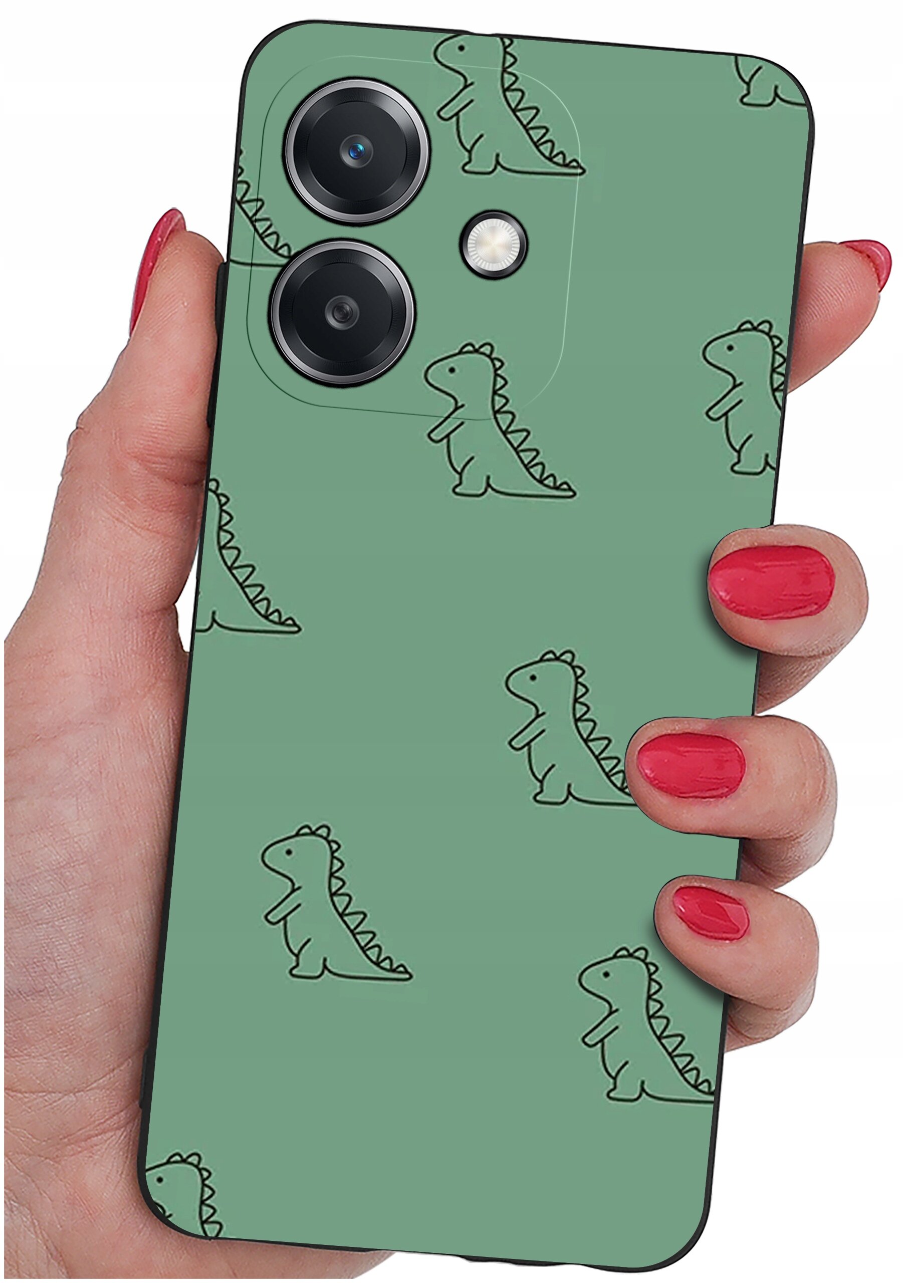 Osoba trzyma telefon z zielonym etui ozdobionym wzorem małych dinozaurów. Etui ma wycięcia na dwa obiektywy aparatu i lampę błyskową.
