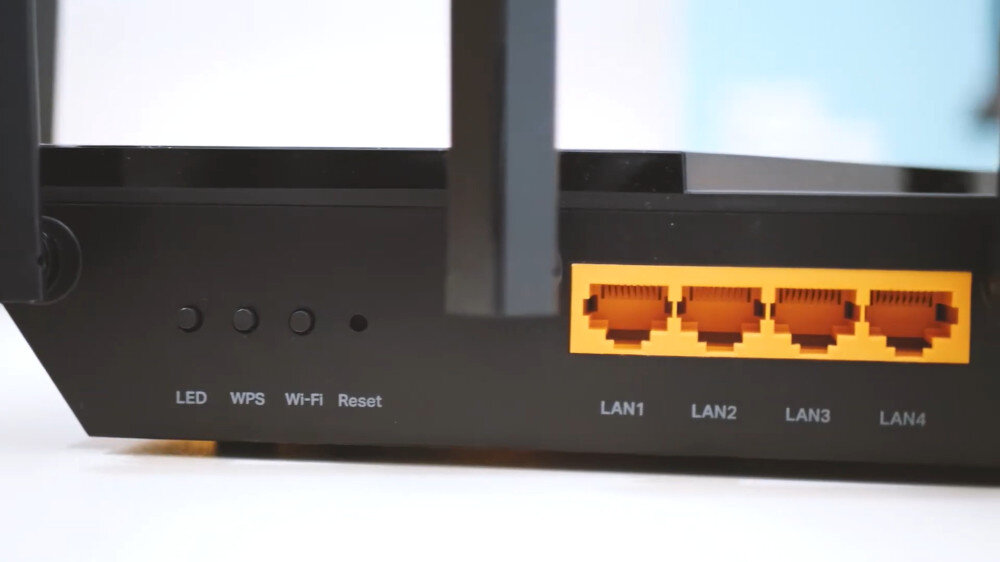Obraz przedstawia tylny panel routera z czterema portami LAN oznaczonymi jako LAN1, LAN2, LAN3, LAN4 oraz przyciskami LED, WPS, Wi-Fi i Reset.