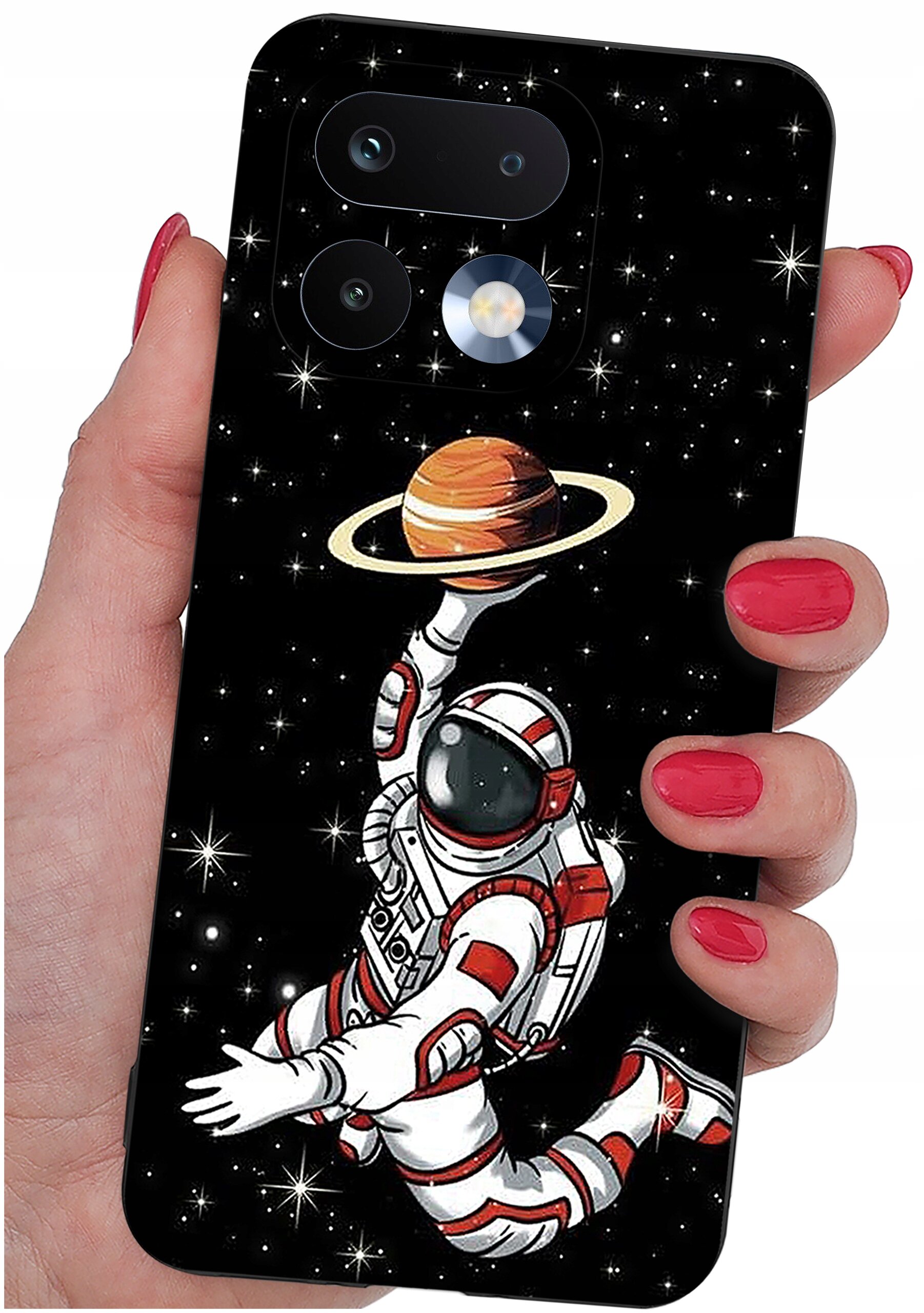 Etui na telefon z grafiką przedstawiającą astronautę unoszącego planetę z pierścieniami na tle gwiazd. Etui trzymane jest w dłoni z pomalowanymi na czerwono paznokciami.