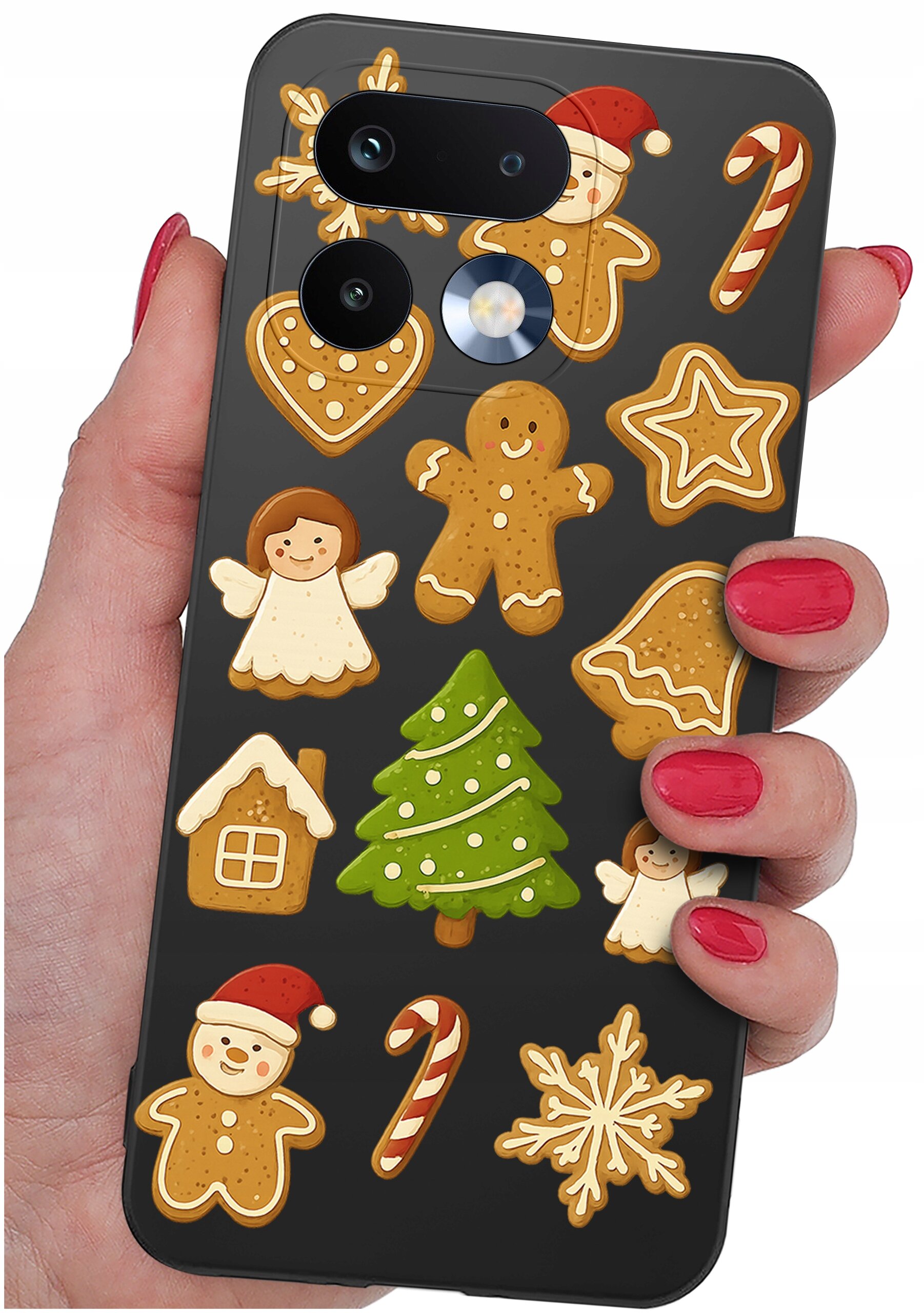 Etui na telefon z motywem świątecznych pierników, w tym choinki, aniołka, laski cukrowej i bałwanka. Etui trzymane jest w dłoni z pomalowanymi na czerwono paznokciami.