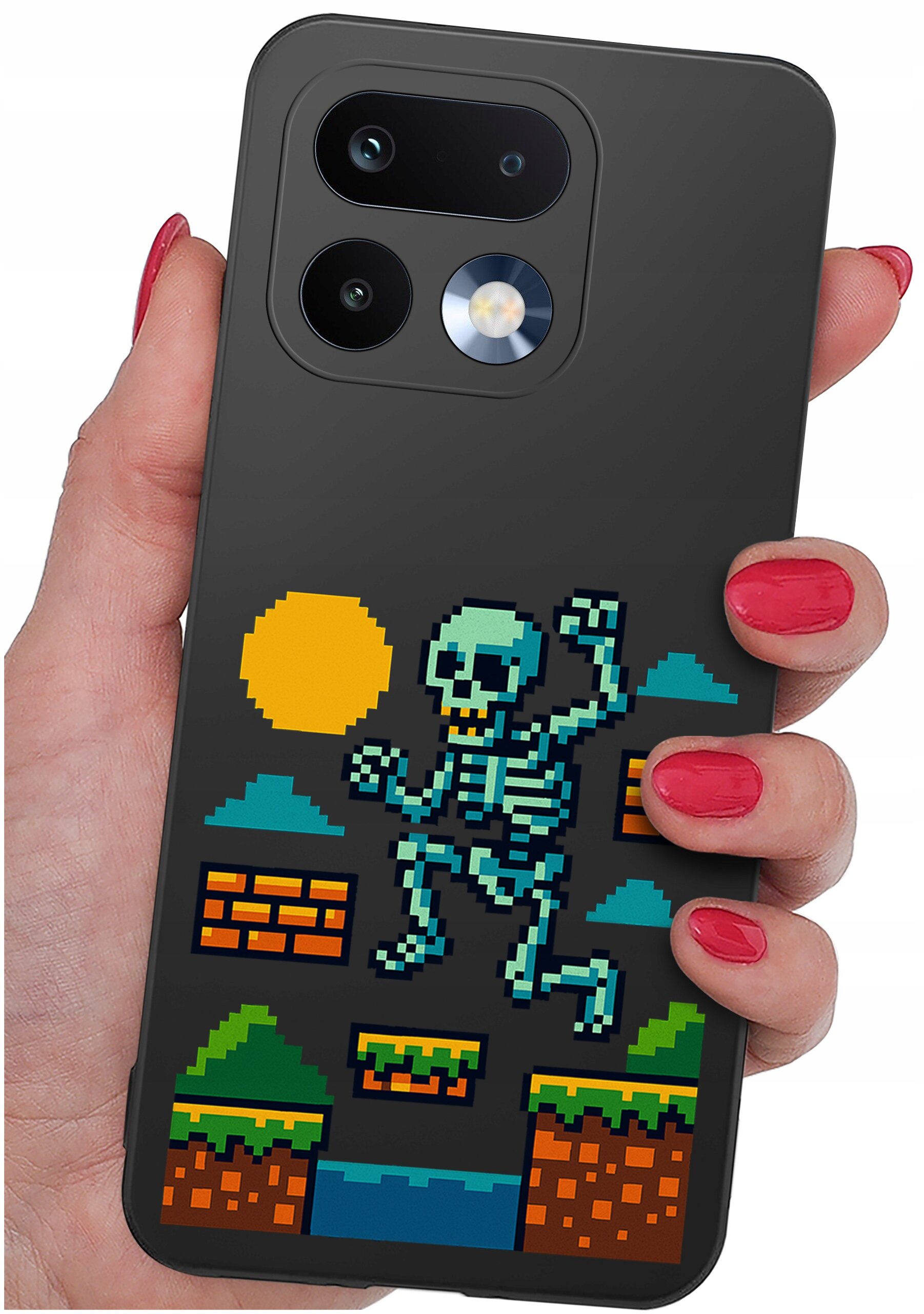 Etui na telefon z grafiką przedstawiającą pikselowego szkieletu skaczącego w scenerii przypominającej grę wideo, z elementami takimi jak słońce, chmury i platformy. Etui trzymane jest w dłoni z pomalowanymi na czerwono paznokciami.